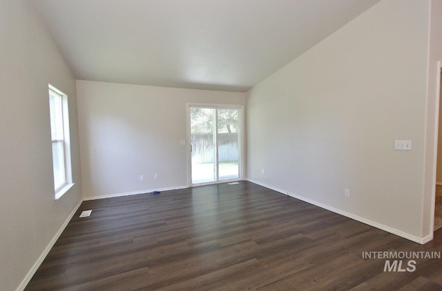 1300 Diamond Ct, Nampa, ID 83686 - spare room featuring vaulted ceiling, healthy amount of natural light, dark wood-type flooring, and baseboards