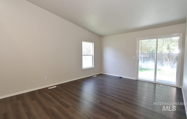 1300 Diamond Ct, Nampa, ID 83686 - spare room with vaulted ceiling, dark wood-style flooring, and baseboards