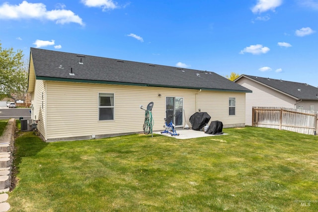 1597 Vista Dr, Twin Falls, ID 83301 - back of property featuring fence, a lawn, a patio area, and central AC