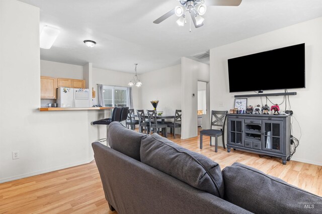 1597 Vista Dr, Twin Falls, ID 83301 - living area featuring baseboards, ceiling fan with notable chandelier, light wood finished floors, and visible vents