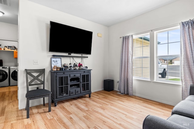 1597 Vista Dr, Twin Falls, ID 83301 - living area featuring plenty of natural light, independent washer and dryer, wood finished floors, and visible vents