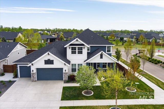 view of front of house with concrete driveway, board and batten siding, a shingled roof, a garage, and a residential view