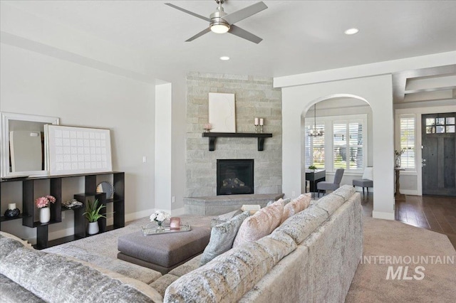 living room with recessed lighting, arched walkways, carpet floors, baseboards, and ceiling fan