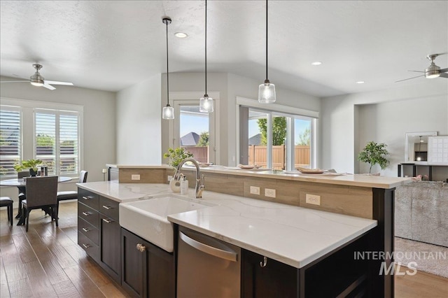 kitchen with dishwasher, a ceiling fan, open floor plan, and a sink