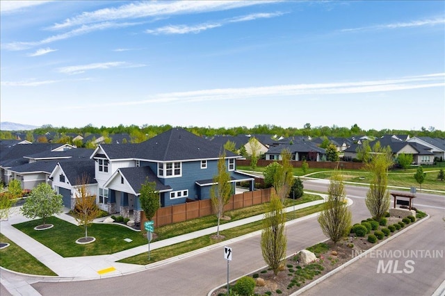 exterior space with a residential view, sidewalks, curbs, and traffic signs