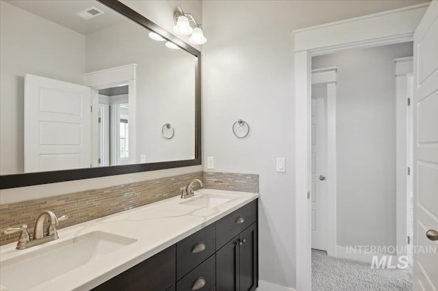 full bathroom with backsplash, double vanity, and a sink