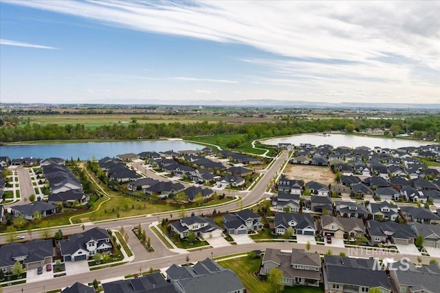 drone / aerial view featuring a residential view and a water view