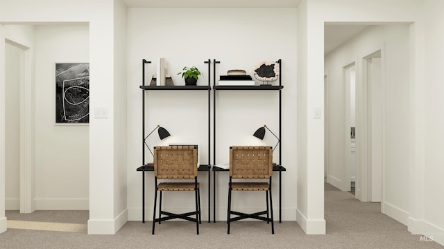 sitting room featuring carpet flooring and baseboards