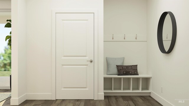 mudroom with dark wood finished floors and baseboards