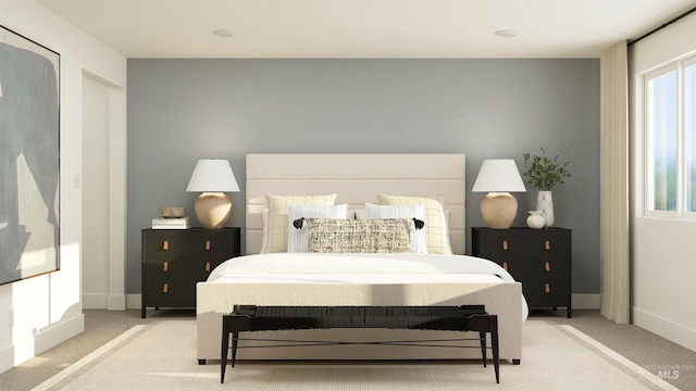 bedroom with light colored carpet and baseboards