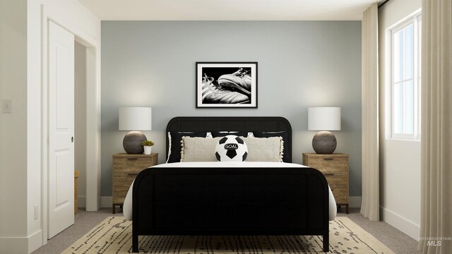 bedroom with baseboards and light carpet