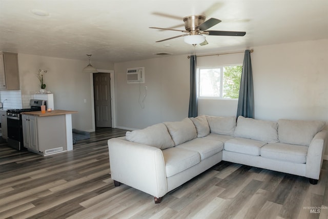 85 E Central Blvd, Cambridge, ID 83610 - living area with wood finished floors, ceiling fan, a wall mounted air conditioner, and baseboards