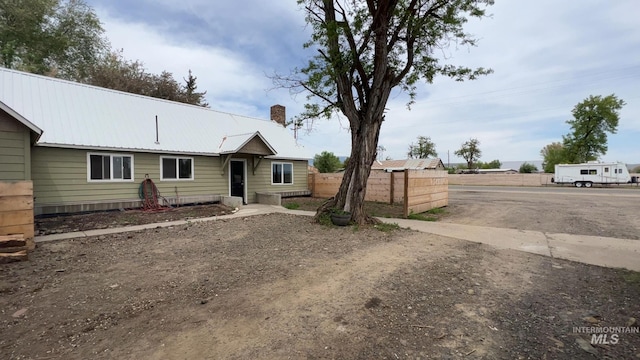 85 E Central Blvd, Cambridge, ID 83610 - view of front of home featuring fence, a chimney, and metal roof
