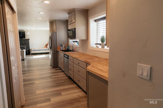 85 E Central Blvd, Cambridge, ID 83610 - kitchen with butcher block countertops, appliances with stainless steel finishes, a sink, light wood finished floors, and gray cabinets
