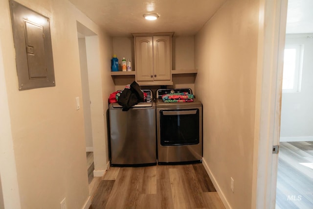 85 E Central Blvd, Cambridge, ID 83610 - clothes washing area featuring separate washer and dryer, electric panel, cabinet space, light wood-style flooring, and baseboards