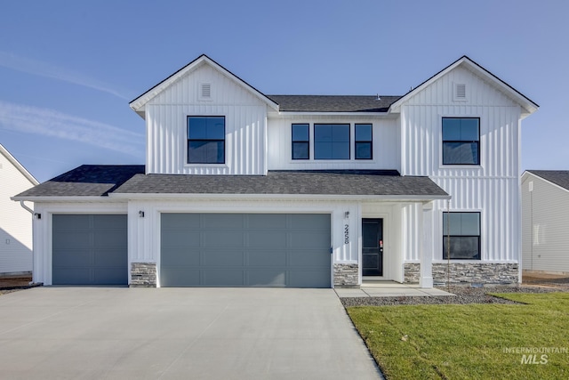 modern farmhouse style home featuring driveway, stone siding, roof with shingles, board and batten siding, and a garage