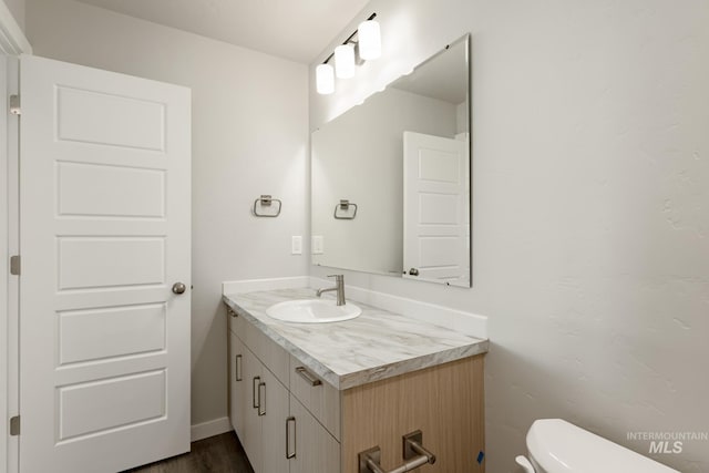 bathroom featuring toilet and vanity