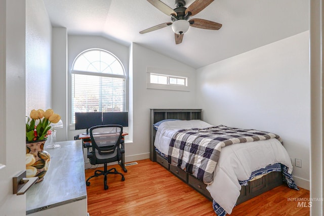 bedroom with baseboards, light wood-style flooring, ceiling fan, and lofted ceiling