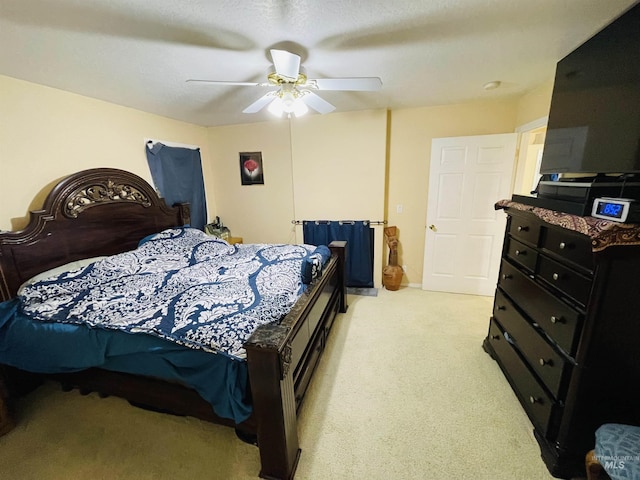 bedroom with light colored carpet and ceiling fan