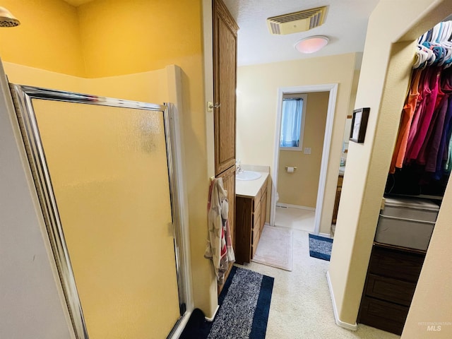 bathroom featuring vanity and walk in shower