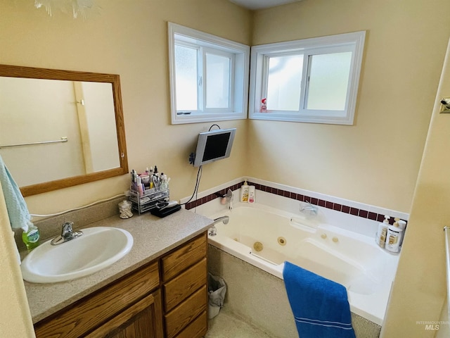 bathroom featuring a tub to relax in and vanity