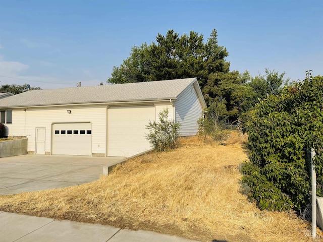 view of side of property with a garage and an outdoor structure