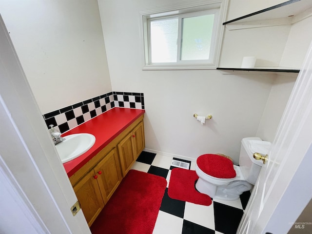 bathroom featuring vanity and toilet