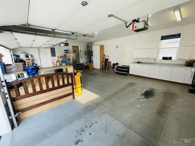 garage featuring secured water heater and a garage door opener