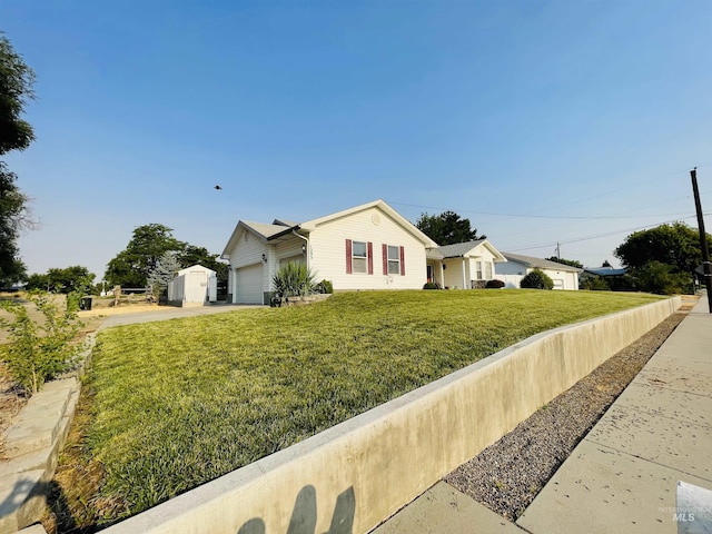 ranch-style home with a garage and a front lawn