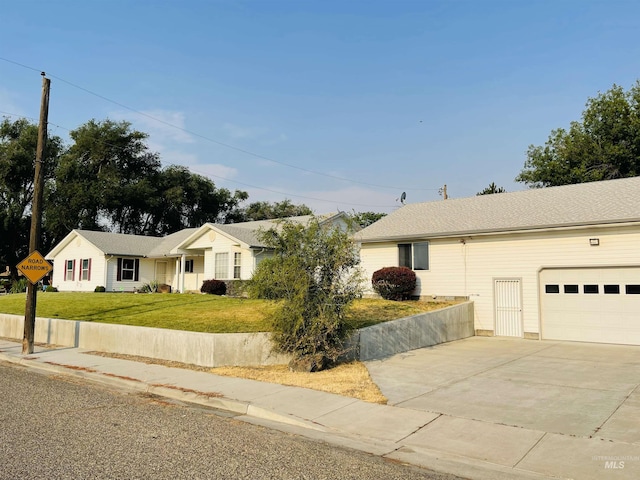 ranch-style home featuring a garage and a front yard