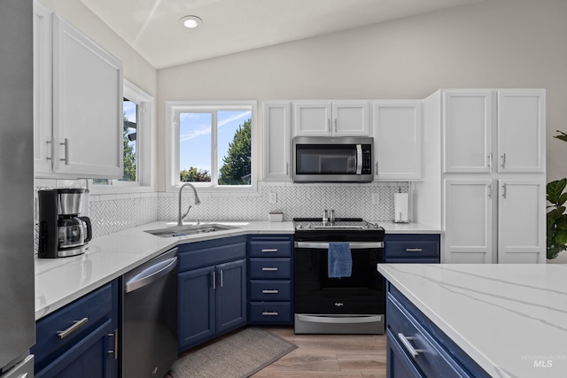 5174 N Rothmans Ave, Boise, ID 83713 - kitchen featuring appliances with stainless steel finishes, blue cabinets, lofted ceiling, tasteful backsplash, and white cabinets