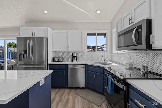 5174 N Rothmans Ave, Boise, ID 83713 - kitchen with appliances with stainless steel finishes, blue cabinetry, white cabinets, healthy amount of natural light, and recessed lighting