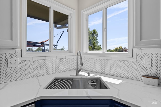 5174 N Rothmans Ave, Boise, ID 83713 - kitchen featuring tasteful backsplash, light stone countertops, and white cabinets