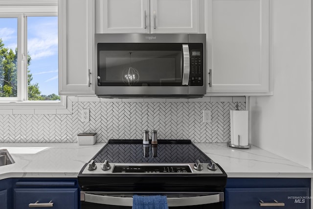5174 N Rothmans Ave, Boise, ID 83713 - kitchen with appliances with stainless steel finishes, tasteful backsplash, white cabinetry, and blue cabinets