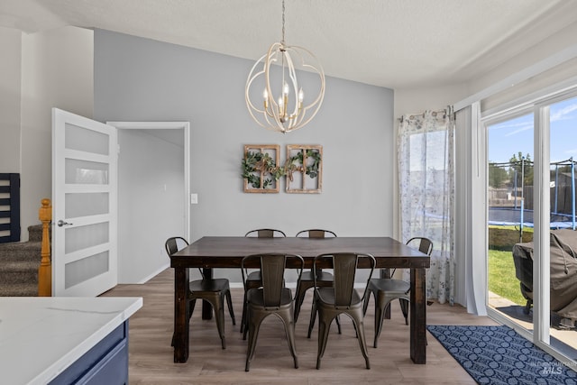 5174 N Rothmans Ave, Boise, ID 83713 - dining space with a chandelier, light wood-style floors, and a textured ceiling