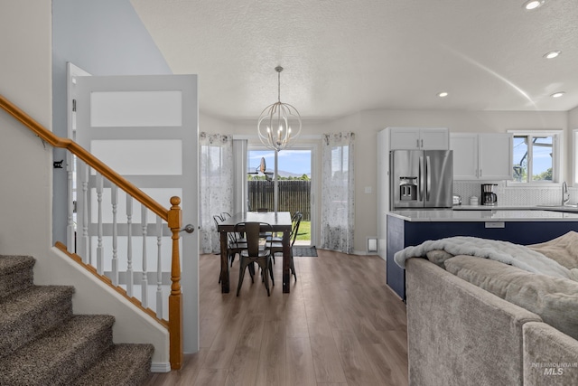 5174 N Rothmans Ave, Boise, ID 83713 - dining area featuring a chandelier, stairs, recessed lighting, light wood-style flooring, and a textured ceiling