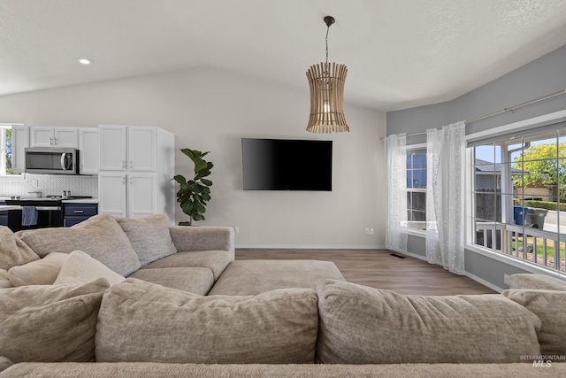 5174 N Rothmans Ave, Boise, ID 83713 - living room with vaulted ceiling, light wood-style flooring, and recessed lighting