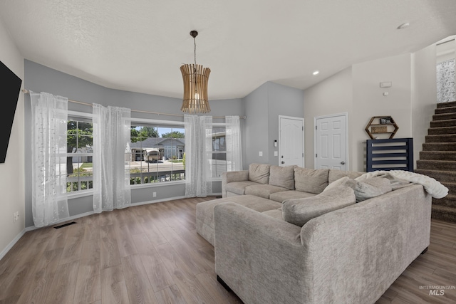 5174 N Rothmans Ave, Boise, ID 83713 - living area with wood finished floors, stairway, recessed lighting, lofted ceiling, and a chandelier