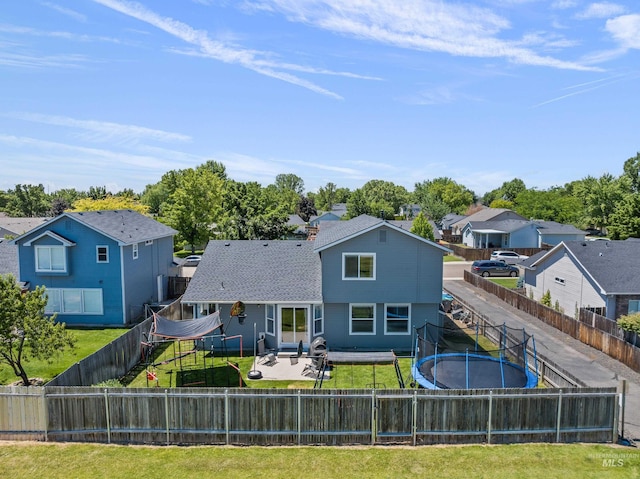 5174 N Rothmans Ave, Boise, ID 83713 - rear view of house featuring a trampoline, a residential view, a fenced backyard, and a patio