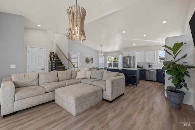 5174 N Rothmans Ave, Boise, ID 83713 - living room featuring recessed lighting, stairway, light wood-type flooring, and vaulted ceiling