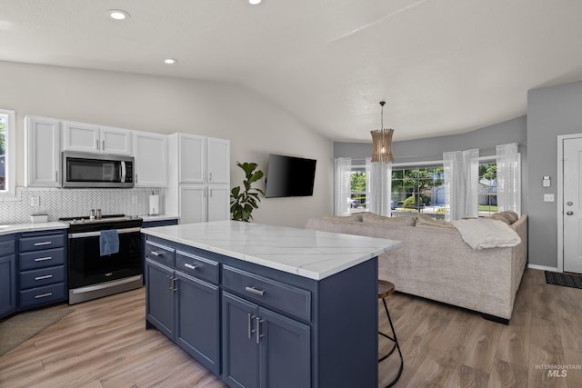 5174 N Rothmans Ave, Boise, ID 83713 - kitchen featuring appliances with stainless steel finishes, lofted ceiling, white cabinetry, blue cabinetry, and decorative backsplash