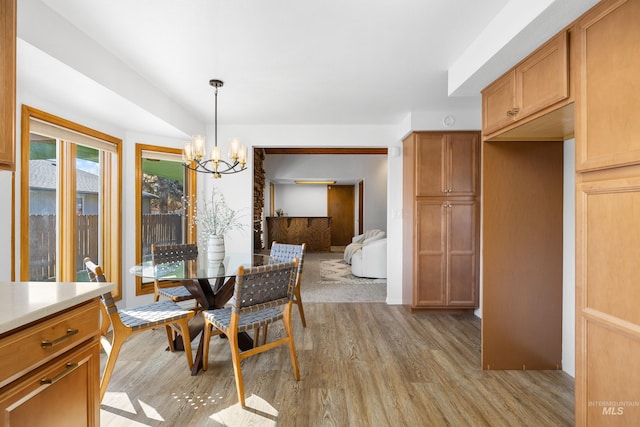 dining space featuring a notable chandelier and light wood-style floors