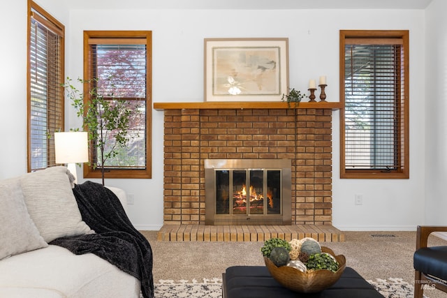 carpeted living room with baseboards and a fireplace