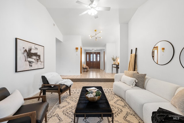 living room featuring baseboards, carpet flooring, high vaulted ceiling, and ceiling fan with notable chandelier
