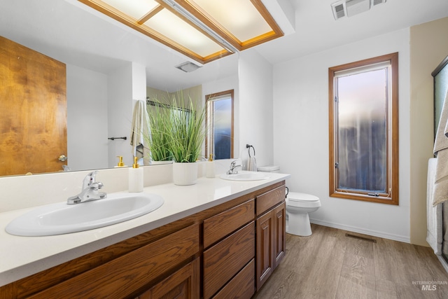 full bathroom with visible vents, toilet, and a sink