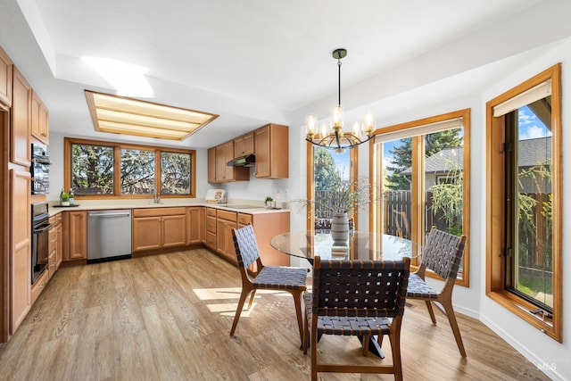 dining space with an inviting chandelier and light wood-style floors