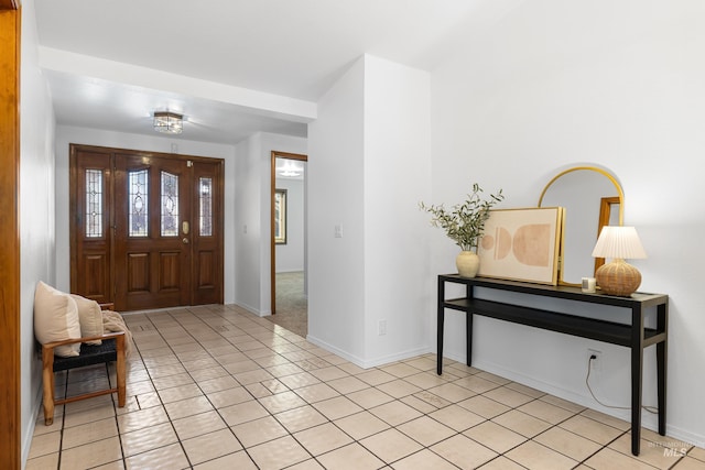 entrance foyer featuring baseboards and light tile patterned floors