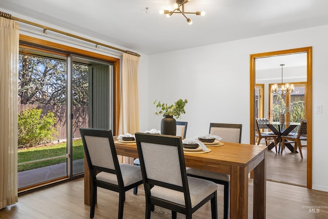 dining room featuring a notable chandelier and light wood finished floors