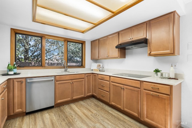 kitchen with a sink, light wood-style floors, dishwasher, a healthy amount of sunlight, and under cabinet range hood