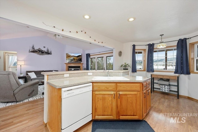 kitchen with light wood-type flooring, white dishwasher, open floor plan, and a sink